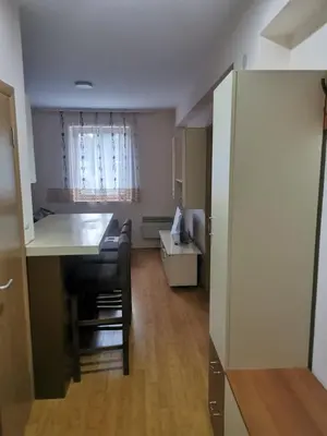 a kitchen with a counter and a table in a room at Apartmani Nedeljkovic Brzece Kopaonik in Brzeće