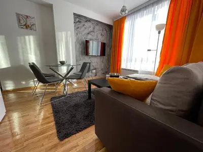 a living room with a couch and a table at Apartments Enzo Kopaonik in Kopaonik