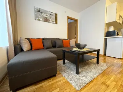 a living room with a couch and a table at Apartments Enzo Kopaonik in Kopaonik