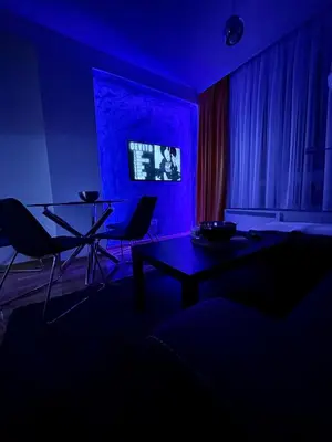 a dark room with a table and chairs in it at Apartments Enzo Kopaonik in Kopaonik