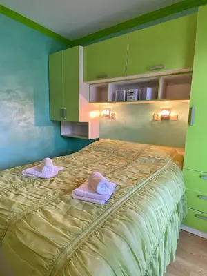a bedroom with a bed with two towels on it at Apartman Marko B in Vrnjačka Banja