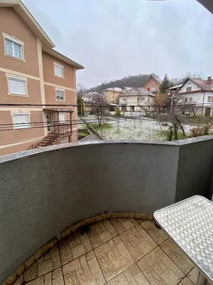 a balcony with a bench and a building at Apartman Marko B in Vrnjačka Banja