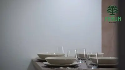a table with bowls and wine glasses on it at PERUN in Vrnjačka Banja