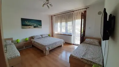 a bedroom with two beds and a window at Studio 2 Miljković in Soko Banja