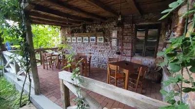 a patio with tables and chairs in a building at Studio 2 Miljković in Soko Banja