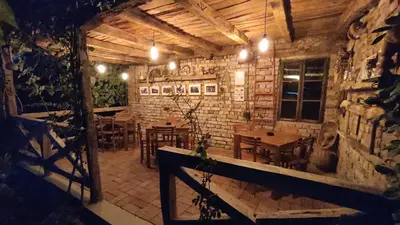 a restaurant with tables and chairs in a brick wall at Studio 2 Miljković in Soko Banja