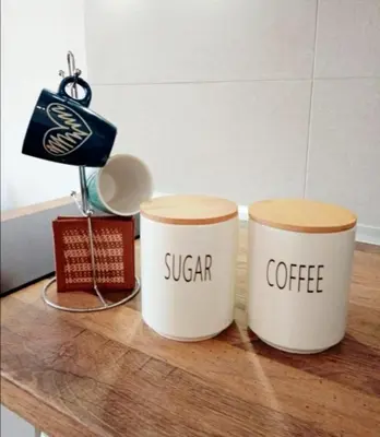 two coffee cups on a wooden table with words sugar coffee at Wolf Apartments Kopaonik in Kopaonik