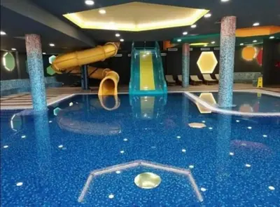 a pool in a cruise ship with a slide at Wolf Apartments Kopaonik in Kopaonik