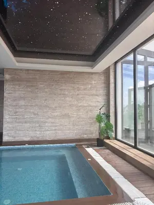 a swimming pool in a house with a window at Mountain Bliss Residence - Milmari Spa & Wellness in Kopaonik