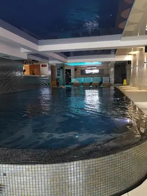 a swimming pool in the middle of a building at Zoned II Kopaonik - Studio Njegomir in Kopaonik