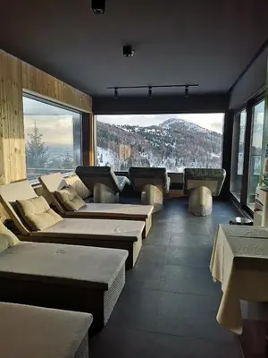 a large room with couches and a large window at Zoned II Kopaonik - Studio Njegomir in Kopaonik