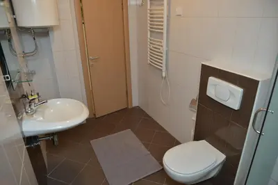 a bathroom with a toilet and a sink at Apartman Ema BIG 64m2-duplex Kopaonik in Kopaonik
