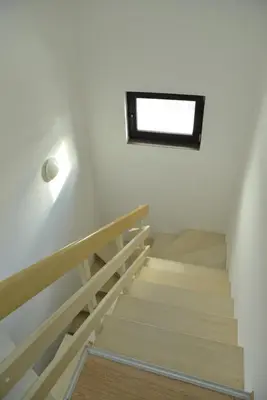 a staircase in a synagogue with a window on the wall at Apartman Ema BIG 64m2-duplex Kopaonik in Kopaonik
