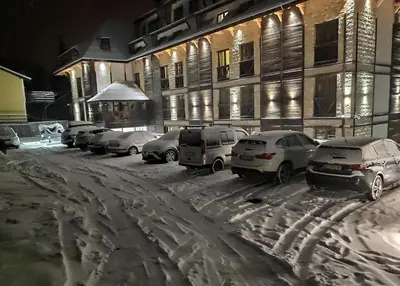 a group of cars parked in a parking lot in the snow at Mountain View 19 Zoned II Kopaonik in Kopaonik