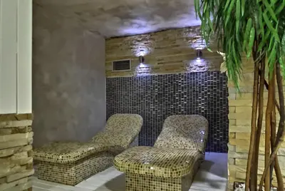 a room with two chairs and a brick wall at Mountain View 19 Zoned II Kopaonik in Kopaonik