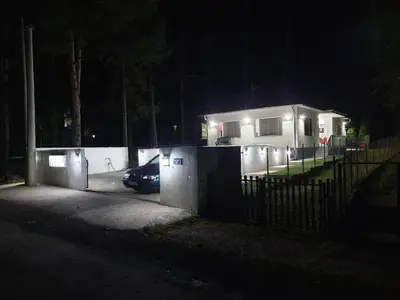 a house at night with a car parked in front of it at Apartmani Grza in Paraćin
