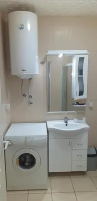a bathroom with a washing machine and a sink at Apartmani Grza in Paraćin