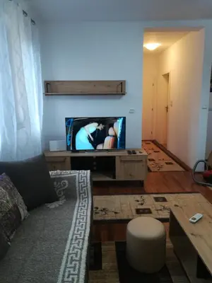 a living room with a couch and a tv at Apartman 2M Lux in Vrnjačka Banja