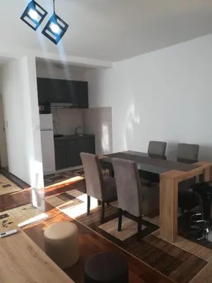 a kitchen and dining room with a table and chairs at Apartman 2M Lux in Vrnjačka Banja