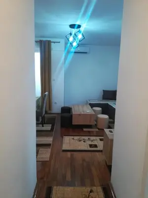 a living room with a blue light on the ceiling at Apartman 2M Lux in Vrnjačka Banja