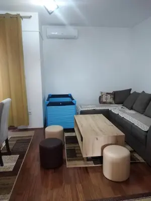 a living room with a couch and a coffee table at Apartman 2M Lux in Vrnjačka Banja