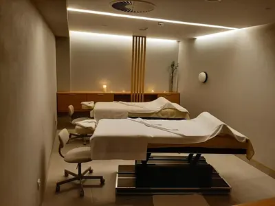 a hospital room with two beds and a chair at Studio Diamondlux Vrnjačka Banja in Vrnjačka Banja