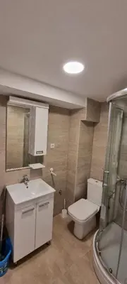 a bathroom with a toilet and a sink and a shower at Iznad oblaka B02 in Kopaonik