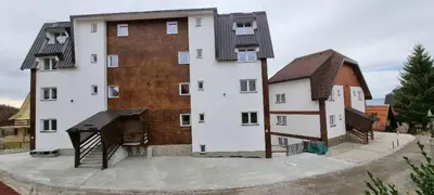 a large building with a house and a piano at Iznad oblaka B02 in Kopaonik
