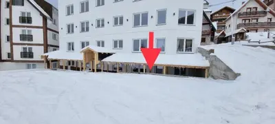 a building with a red arrow in the snow at Iznad oblaka B02 in Kopaonik