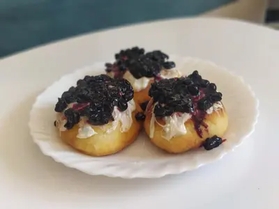 three donuts on a white plate on a table at Beli Vuk in Kopaonik