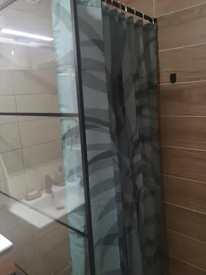 a shower curtain in a bathroom with a sink at Beli Vuk in Kopaonik