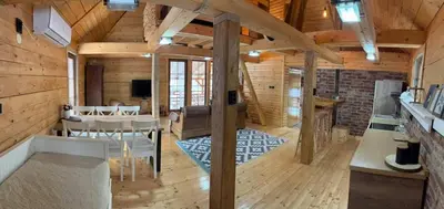 a living room with a table and a dining room at Lozanski ambar in Boljevac