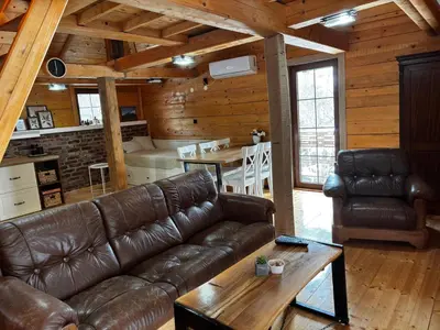 a living room with a leather couch and a table at Lozanski ambar in Boljevac