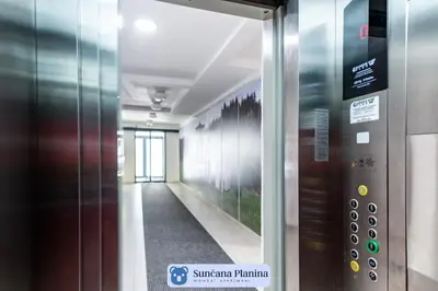 an elevator in a building with a hallway at Sunčana Planina - Apartmani Wombat in Kopaonik