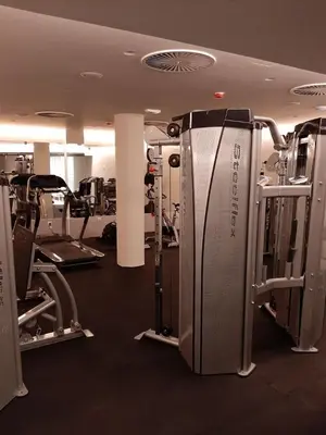 a gym with treadmills and machines in a room at Apolon Spa in Vrnjačka Banja