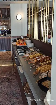 a buffet line in a restaurant with lots of food at Apolon Spa in Vrnjačka Banja