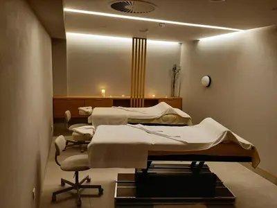 a hospital room with two beds and a mirror at Apolon Spa in Vrnjačka Banja