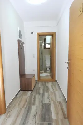 an empty bathroom with a toilet and a door at Kopaonik Apartman Sanja in Kopaonik