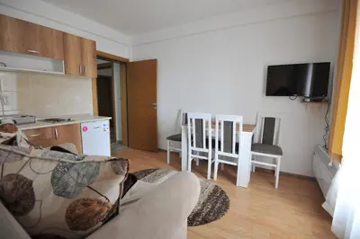 a living room with a couch and a kitchen at Kopaonik Apartman Sanja in Kopaonik
