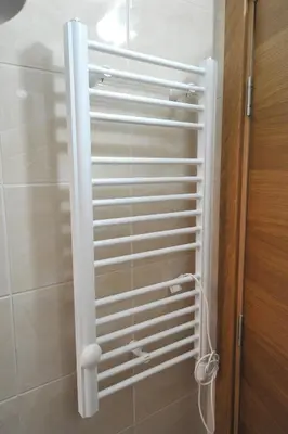 a white radiator in a bathroom next to a shower at Kopaonik Apartman Sanja in Kopaonik
