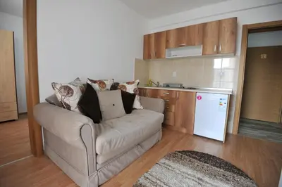 a living room with a couch and a kitchen at Kopaonik Apartman Sanja in Kopaonik
