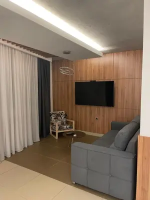 a living room with a couch and a flat screen tv at Leo lux 1 in Niš