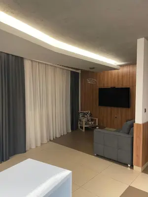 a living room with a couch and a flat screen tv at Leo lux 1 in Niš