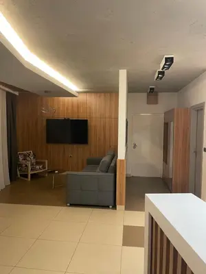 a living room with a couch and a flat screen tv at Leo lux 1 in Niš