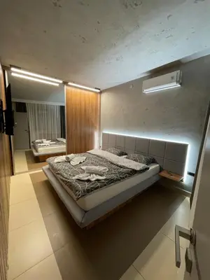 a bedroom with a large bed in a room at Leo lux 1 in Niš
