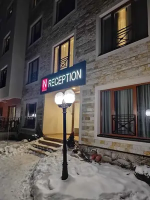a street light in the snow in front of a building at MILMARI Kop N10 in Kopaonik