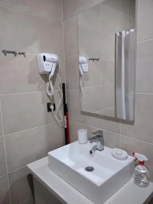 a bathroom with a white sink and a mirror at MILMARI Kop N10 in Kopaonik