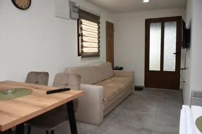 a living room with a couch and a table at Vikendica Čeperković #3 in Kopaonik