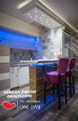 a kitchen with purple stools at a counter at Spa Apartman URBAN Life ZAJEČAR in Zaječar
