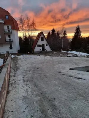 an empty parking lot in front of a house at KopStar Apartment Kopaonik G2 in Kopaonik
